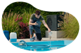 A pool and spa contractor adds chemicals to a new swimming pool.