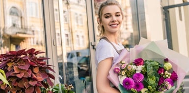 Woman purchasing roses from a florist.