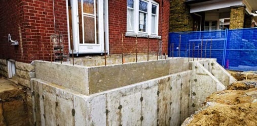 Building addition to residential house with new foundation.