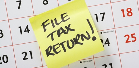 Post it reminder on calendar to file a tax return.