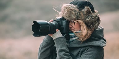 A photographer takes a photo at a winter session.