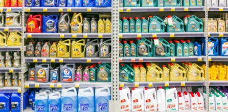 Detergent lined up on store shelves for sale.