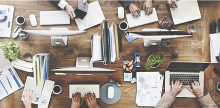 A cluttered workspace shown from above.