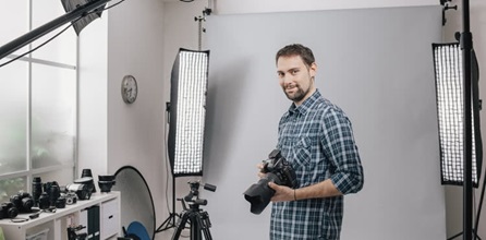 A professional photographer with cameras and equipment