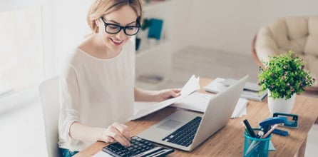 A woman using her calculator to determine consulting fees