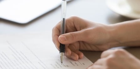 Business person signing license paperwork