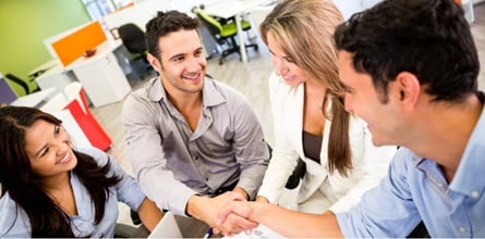 Small business owner shaking hands with referred customer.