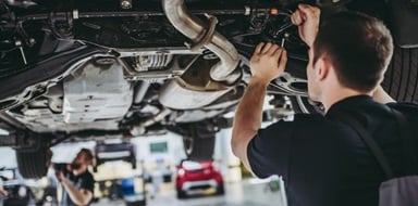 Garage mechanic working on a customer's vehicle.