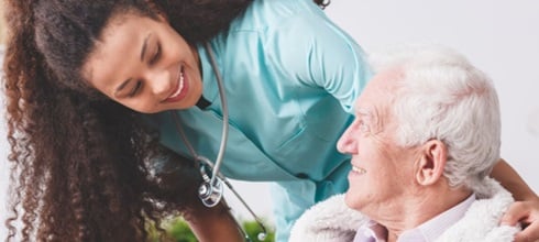 A nurse helping an elderly patient