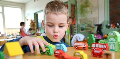 Child playing with toys in a daycare center.