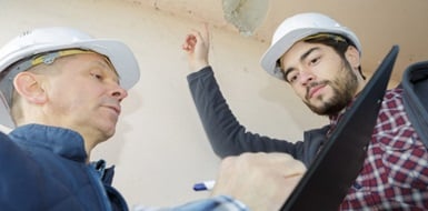 Construction workers discussing a document