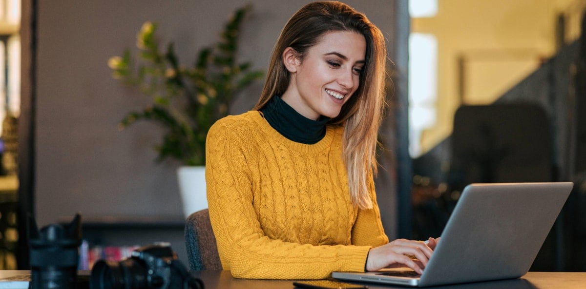 A gig worker planning on her laptop. A gig worker planning on her laptop.