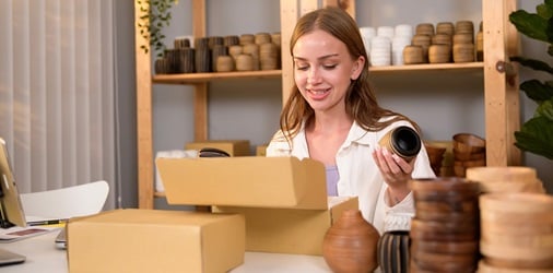 Etsy seller boxing up item for delivery