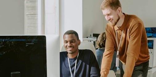 Two cybersecurity specialists performing pen testing for a small business.