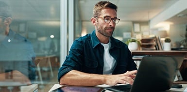 Person working on a laptop in a modern office.