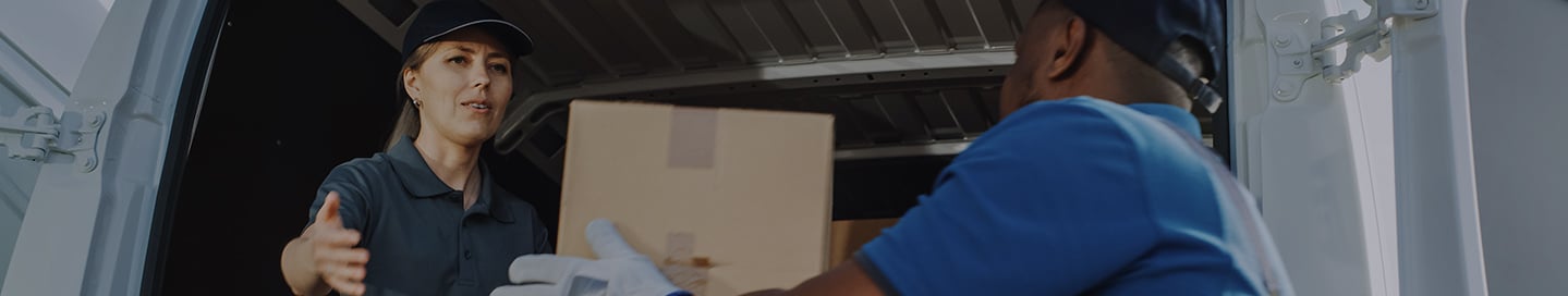 Cannabis transportation employees load cannabis products onto a truck. Cannabis transportation employees load cannabis products onto a truck.