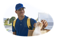 A Grubhub driver hands a meal to a customer.