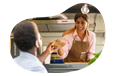 A food trailer business owner hands a customer their order