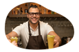 A mobile bartender hands drinks to customers.