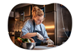 A personal chef slices mushrooms for a dish.