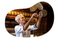 A chef tosses pizza dough in the air.